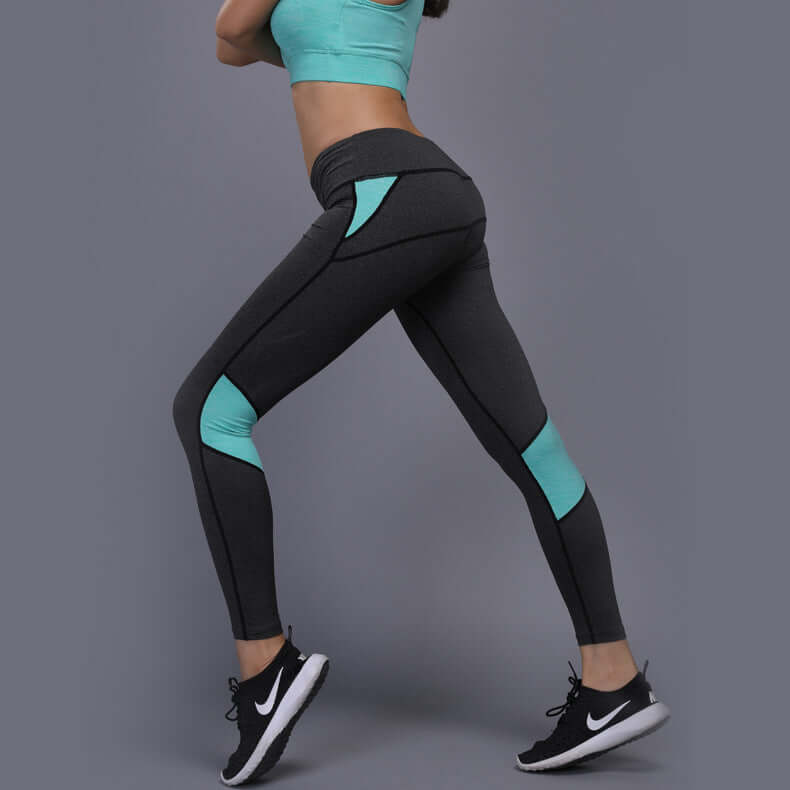 Athletic mesh panel leggings in black and turquoise with polyester blend fabric, side view showcasing flexibility and style during workout.