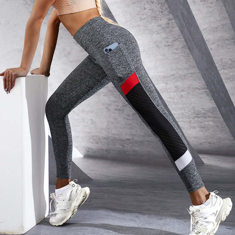 Woman wearing grey mesh pocket leggings, showcasing flexible sporty fit and design detail, ideal for workouts and casual wear.