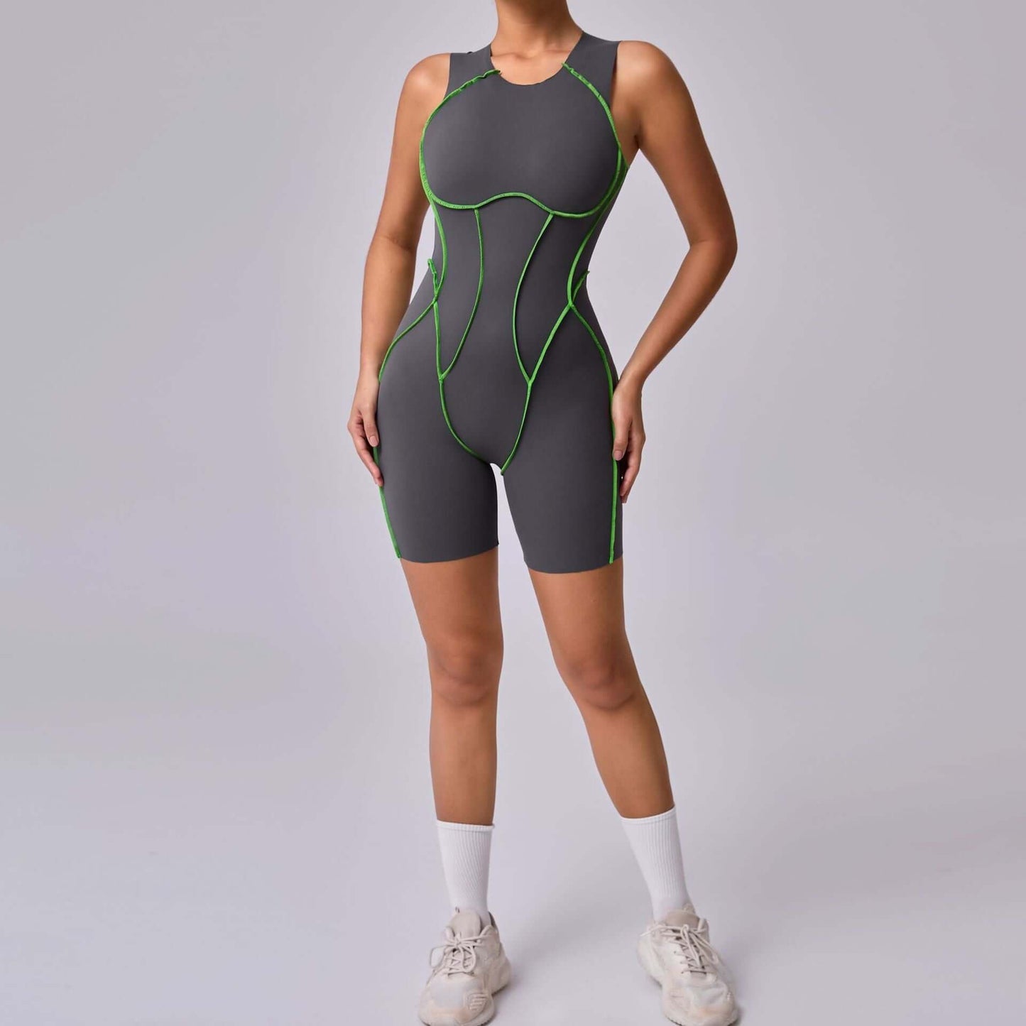 Women's seamless compression jumpsuit with green accents, perfect for fitness and activewear.