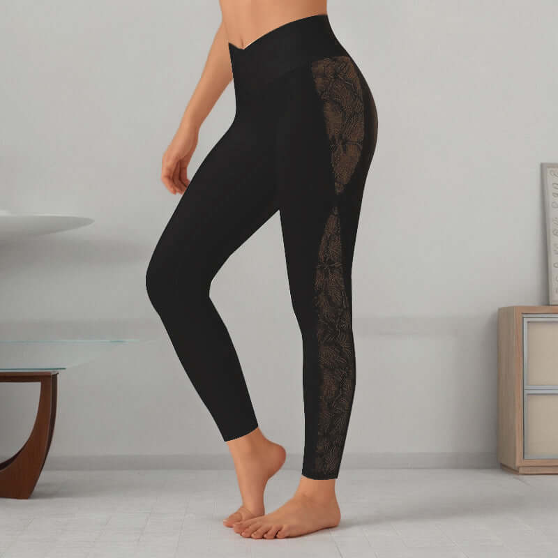 Woman wearing black slim fit leggings with lace detailing on the side, standing in a minimalist room with modern decor.