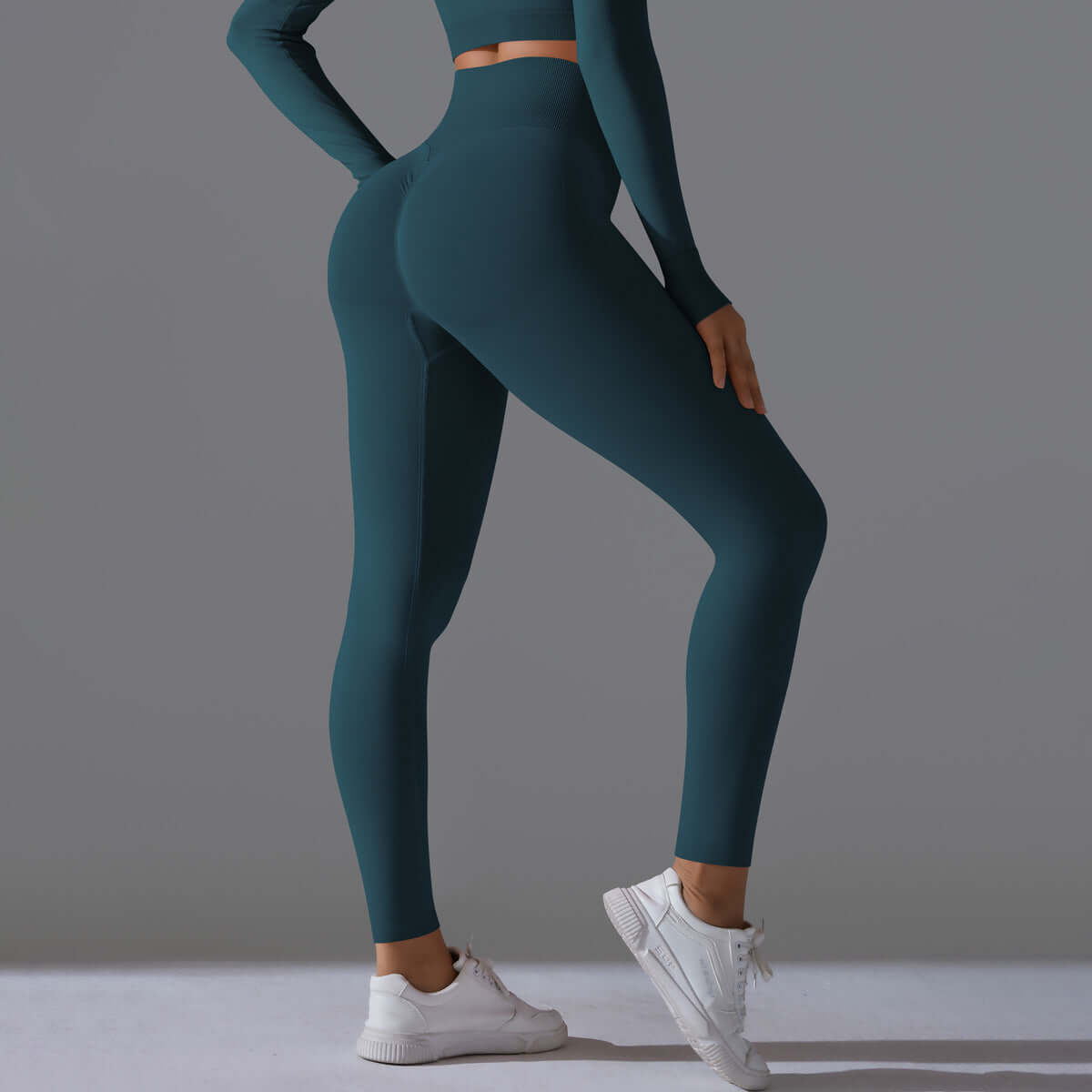 Seamless high waist leggings in teal, featuring a snug fit for comfort and style, paired with white sneakers.