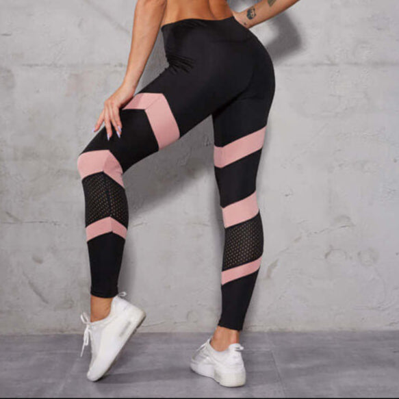 Woman wearing breathable workout leggings with pink accents, showcasing comfort and style. Available in XS-L sizes, perfect for fitness.