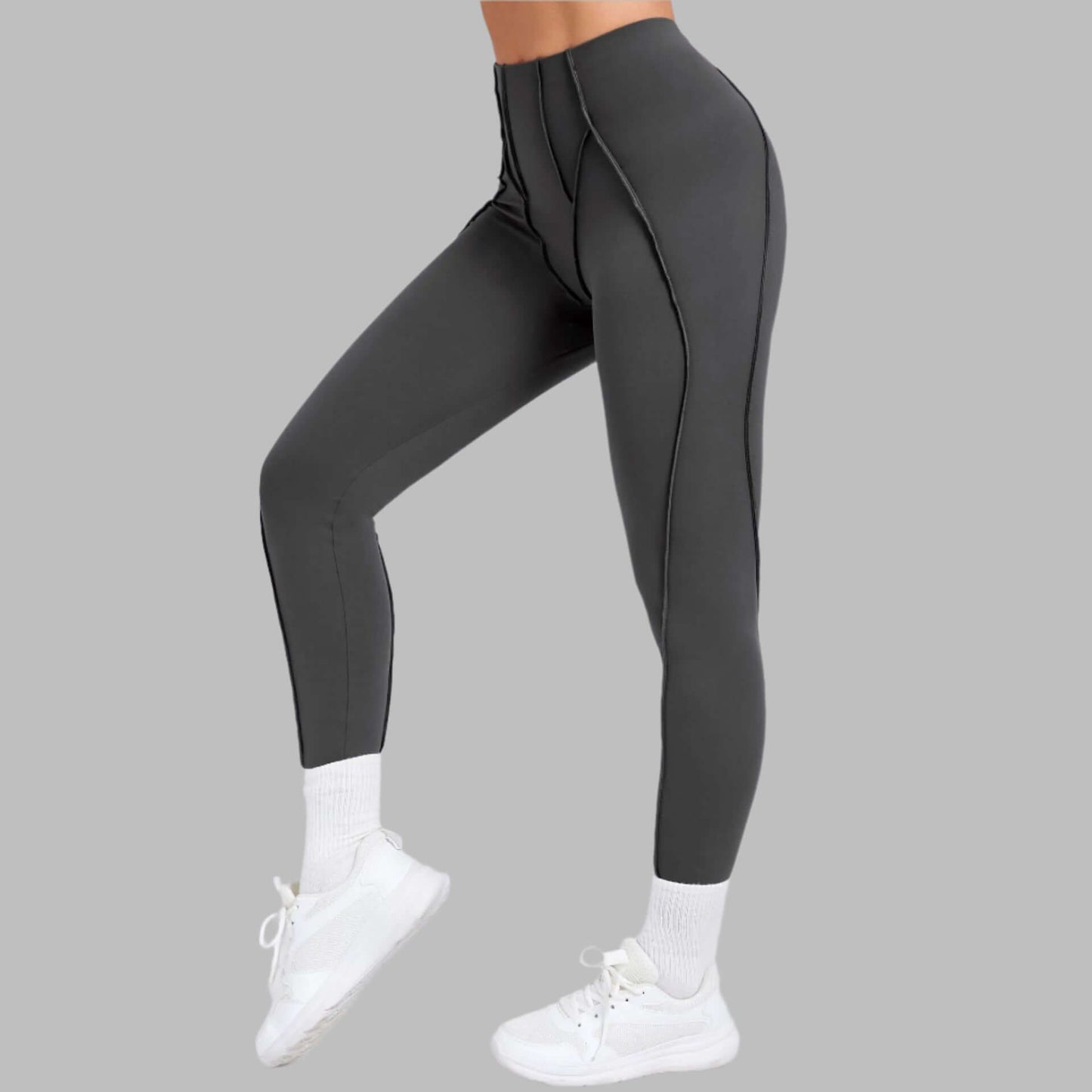 Grey compression gym leggings on model, side view, showcasing high waist and form-fitting design for active wear.