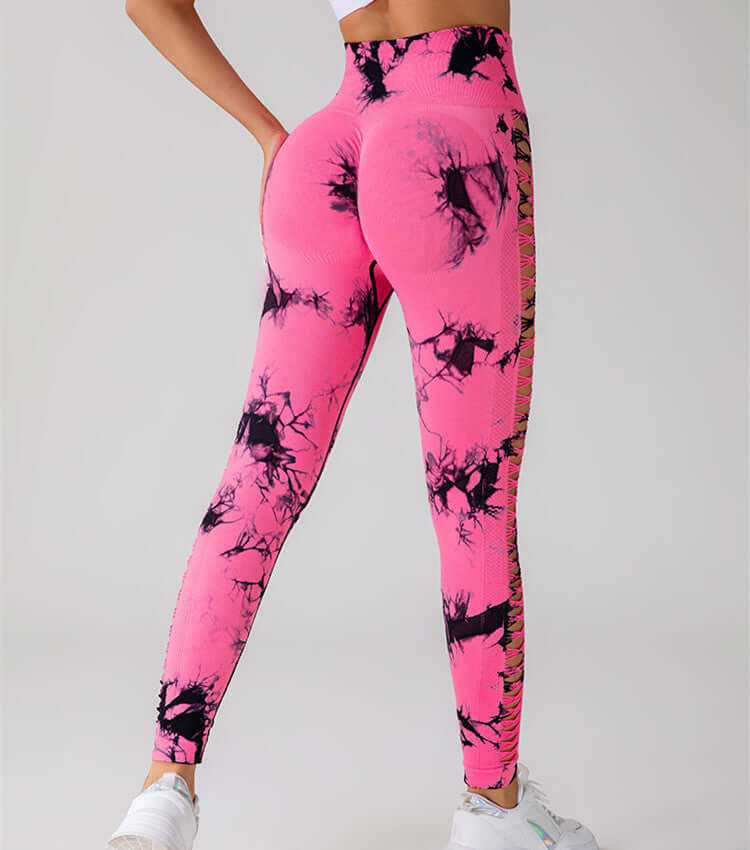 Pink butt-lift gym leggings with black tie-dye pattern, showcased in a dynamic pose, highlighting form-fitting and stylish design.