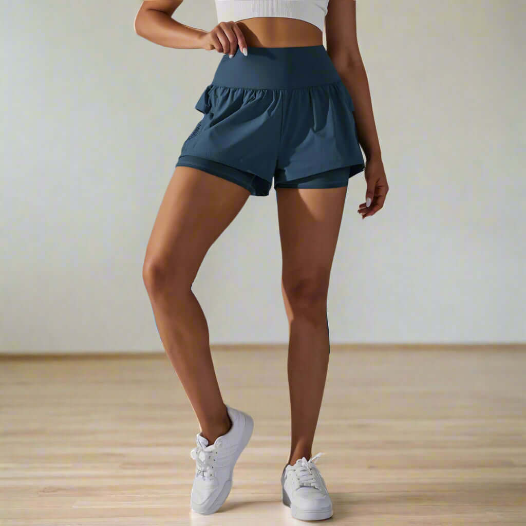 Woman wearing double layer yoga shorts with high-waist design, perfect for running and active summer days.