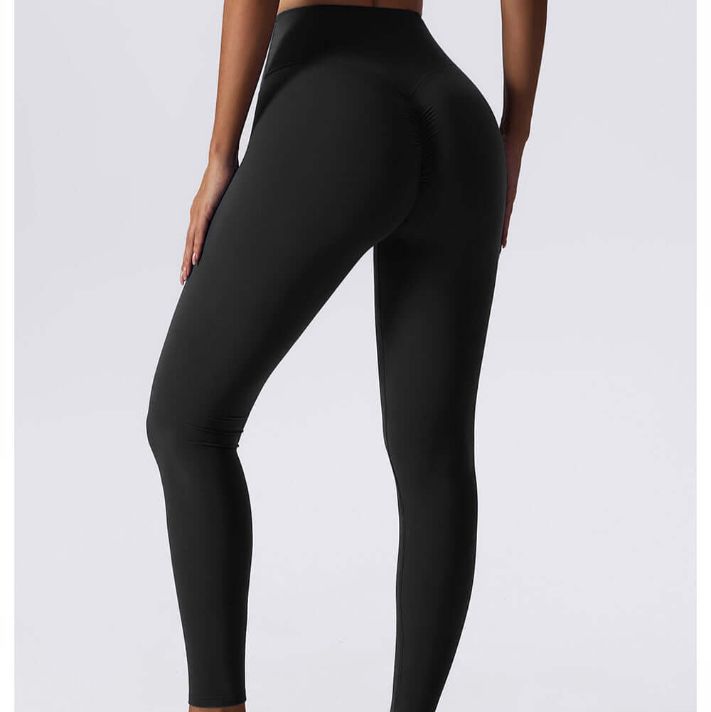 Model wearing black drawstring yoga leggings with a high waist, showing seamless fit and comfort ideal for workouts.
