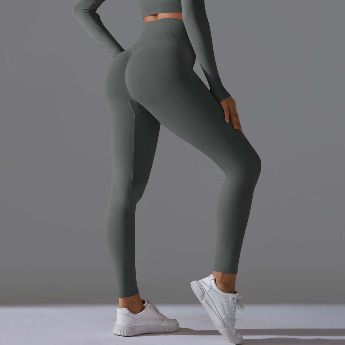 Alt Tag: Seamless high waist leggings in grey, designed for comfort and style, shown with a matching top and sneakers for a sporty look.