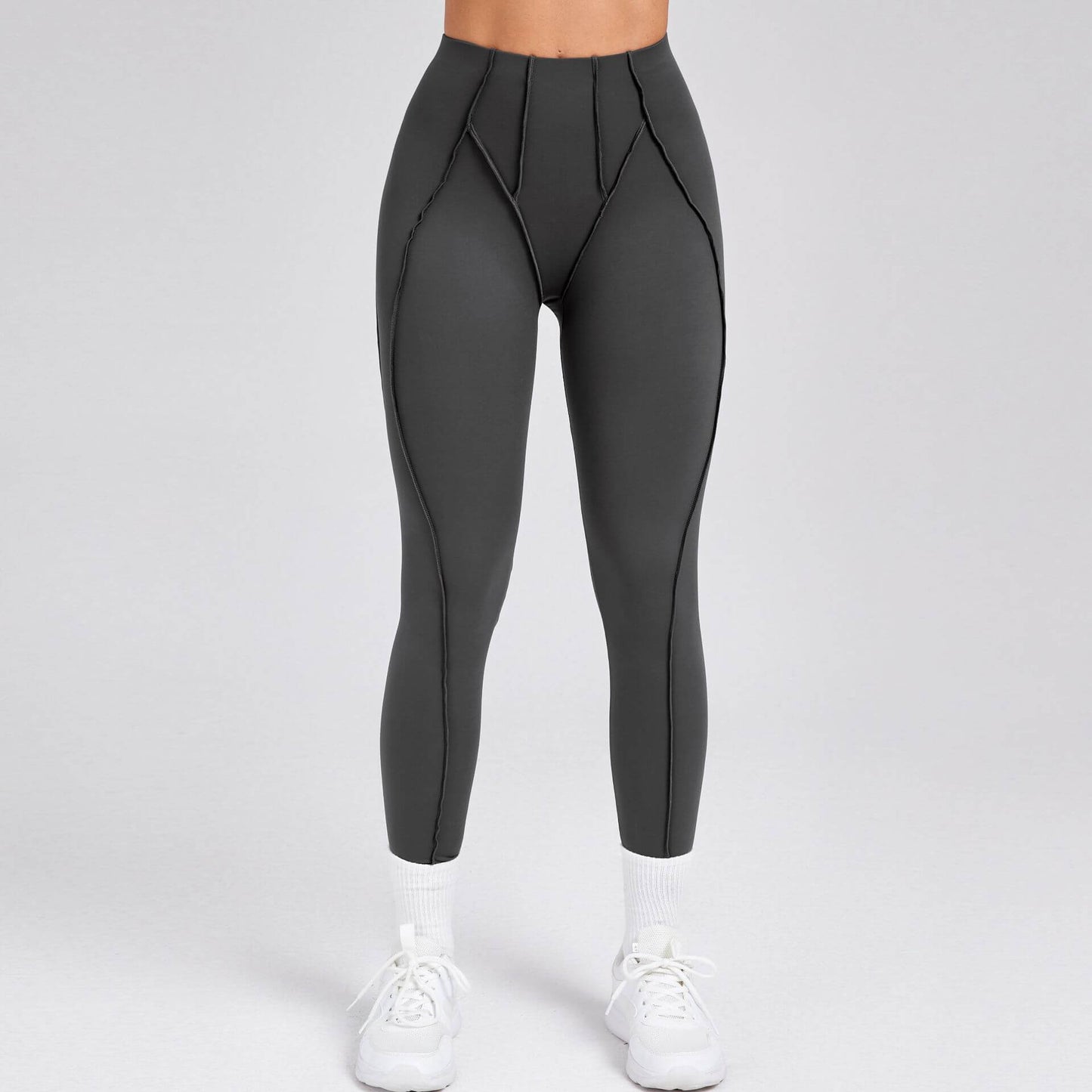 Women's compression gym leggings in dark grey, offering a sleek and supportive fit for enhanced athletic performance.
