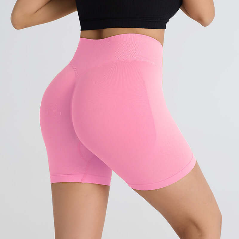 Pink booty-lifting sports shorts enhancing curves, side view