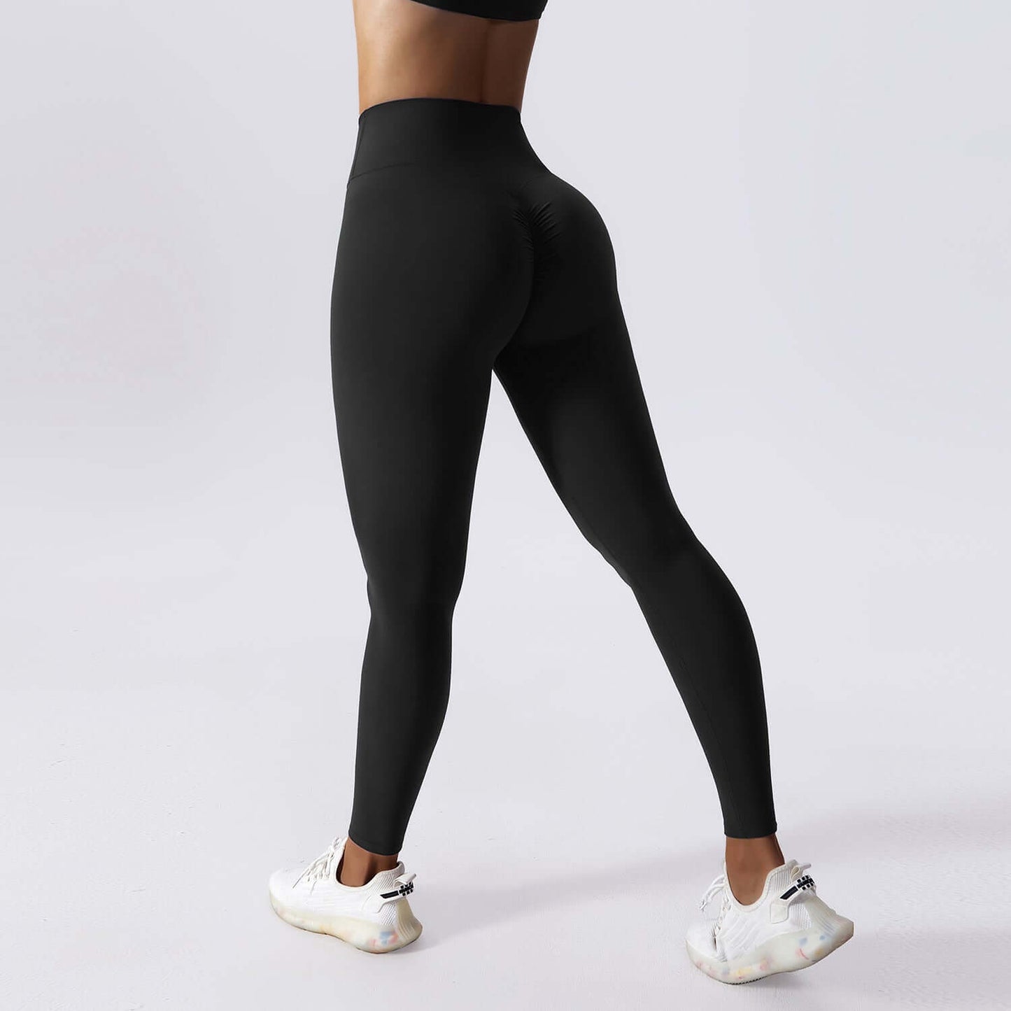 Premium black drawstring yoga leggings with high waist and seamless fit, worn by a woman for workouts or casual comfort.