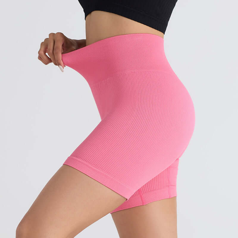 Seamless stretch shorts in berry color, showing flexible and breathable fabric, ideal for fitness or yoga. Size shown: S.