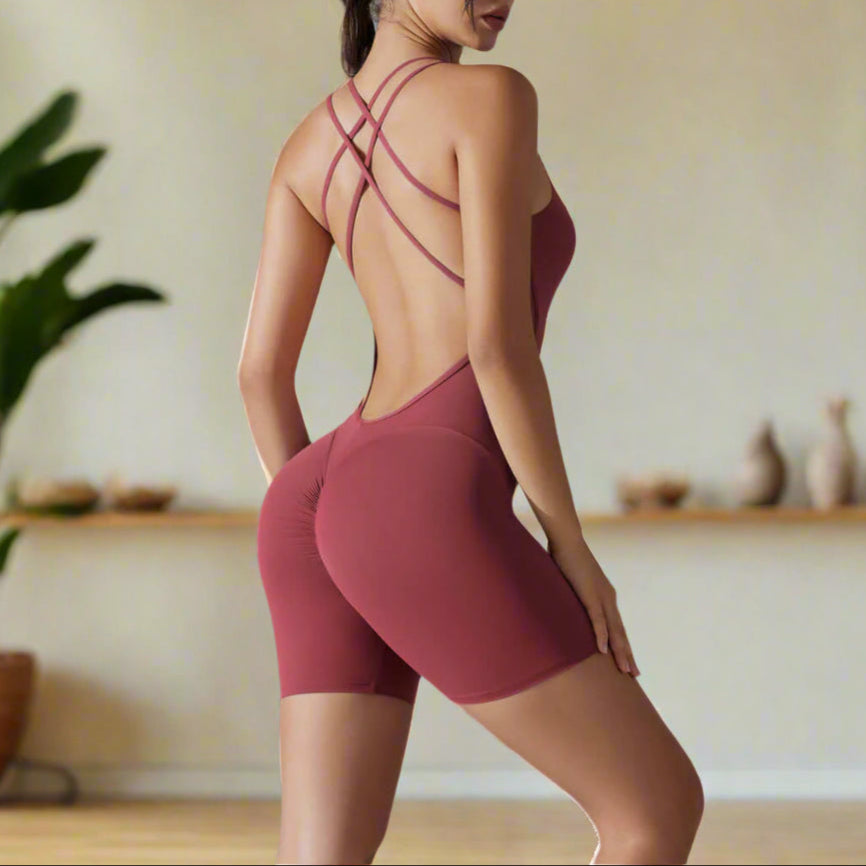 Woman wearing shaping one-piece shorts yoga outfit in organic cotton. Features relaxed fit and breathable material.