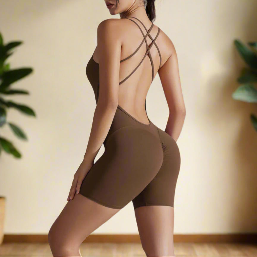Woman wearing shaping one-piece shorts yoga outfit in brown. Features organic cotton, breathable material, relaxed fit for comfort.