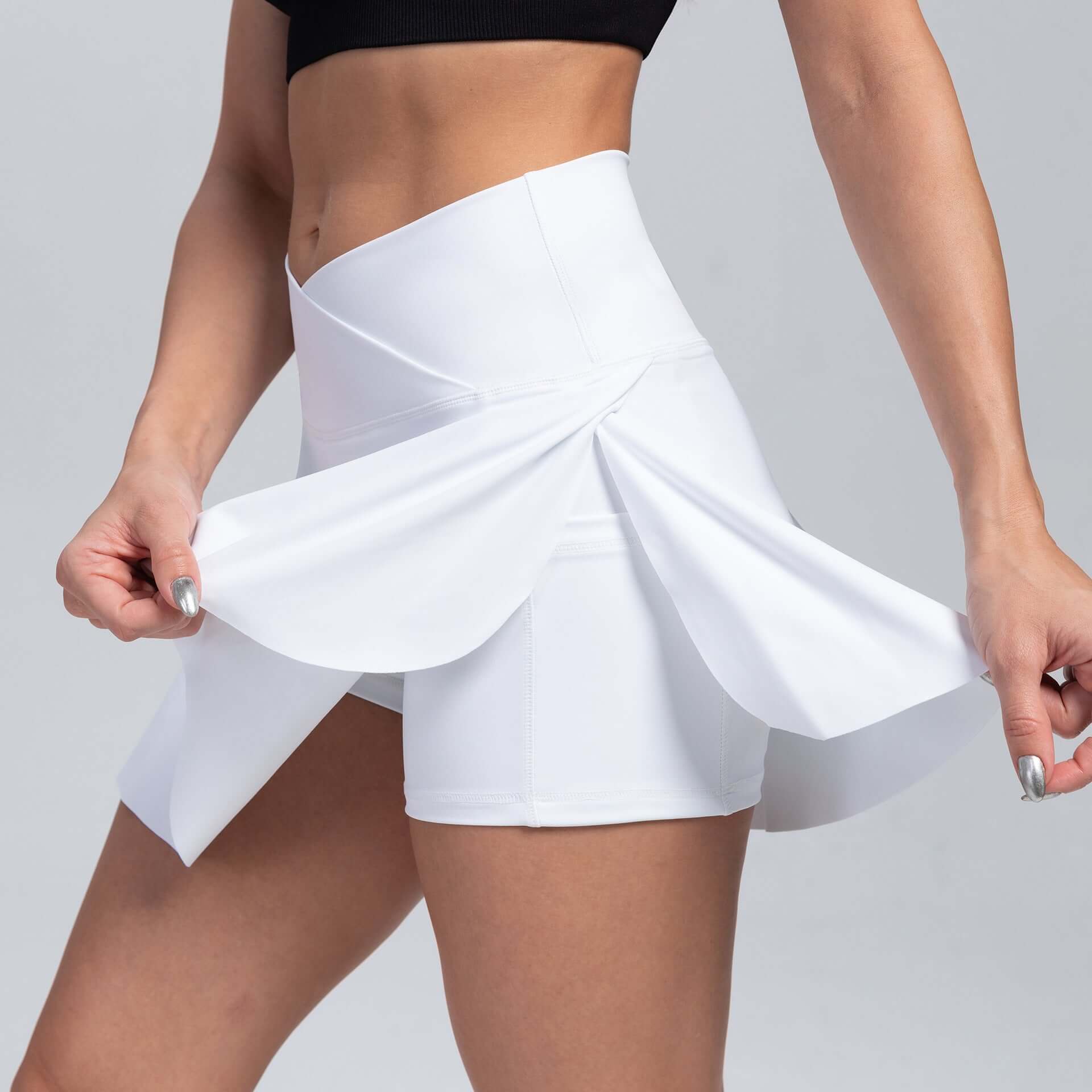 White sport yoga shorts with built-in skirt design for women, moisture-wicking, suitable for all seasons, solid color, blended fabric.