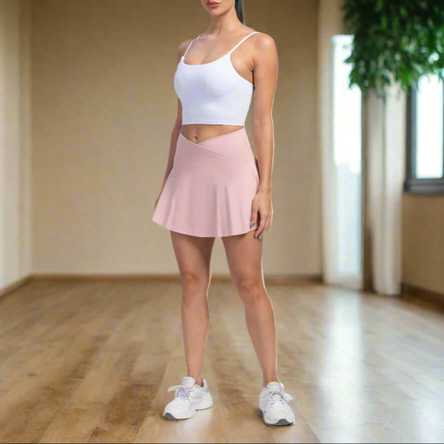Woman wearing sport yoga shorts with built-in skirt design, ideal for all seasons. Perfect for absorbing moisture and sweat during workouts.