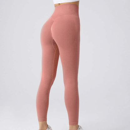 Woman wearing pink workout running leggings in size options S, M, L for 40-65 kg. Comfortable and flexible fit for exercise.