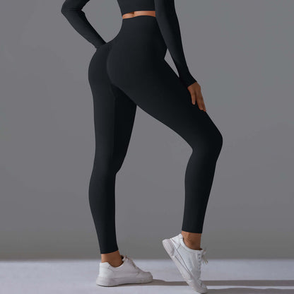 Woman wearing black seamless high waist leggings with white sneakers, showcasing a stylish and comfortable athletic outfit.