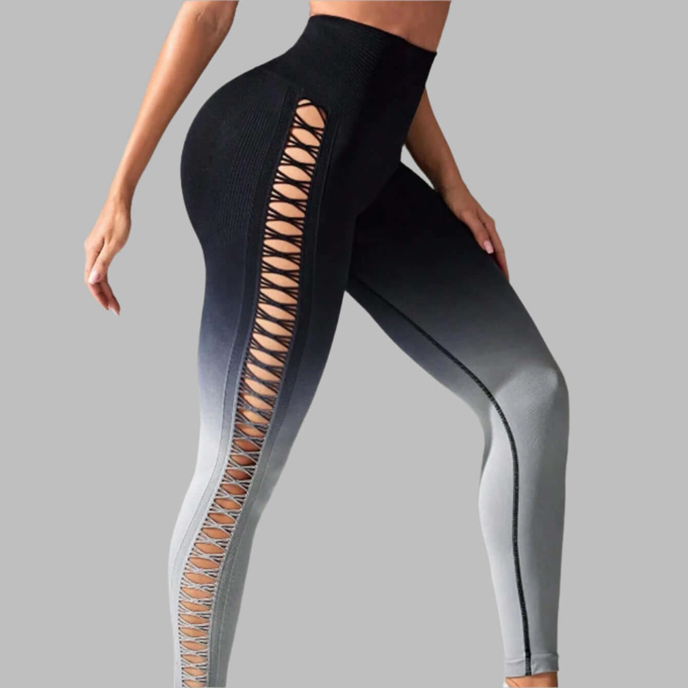 Gradient booty leggings with lattice cutout design in black and gray, highlighting sleek fit and style on model.