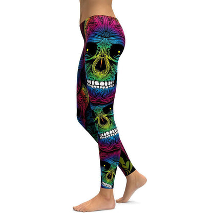 Colorful rainbow skull design leggings displayed from the side, perfect for yoga or casual wear.