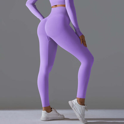 Woman wearing seamless high waist leggings in fantasy purple, showcasing stretch and fit, perfect for yoga and athletic activities.