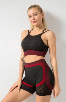 Woman wearing a black and red 2PCS gym set, featuring a sports bra and high-waisted shorts, ideal for fitness and athletic activities.