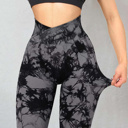 Black and gray tie dye leggings with high waist and stretchy fit, shown on a model pulling the fabric to display flexibility.