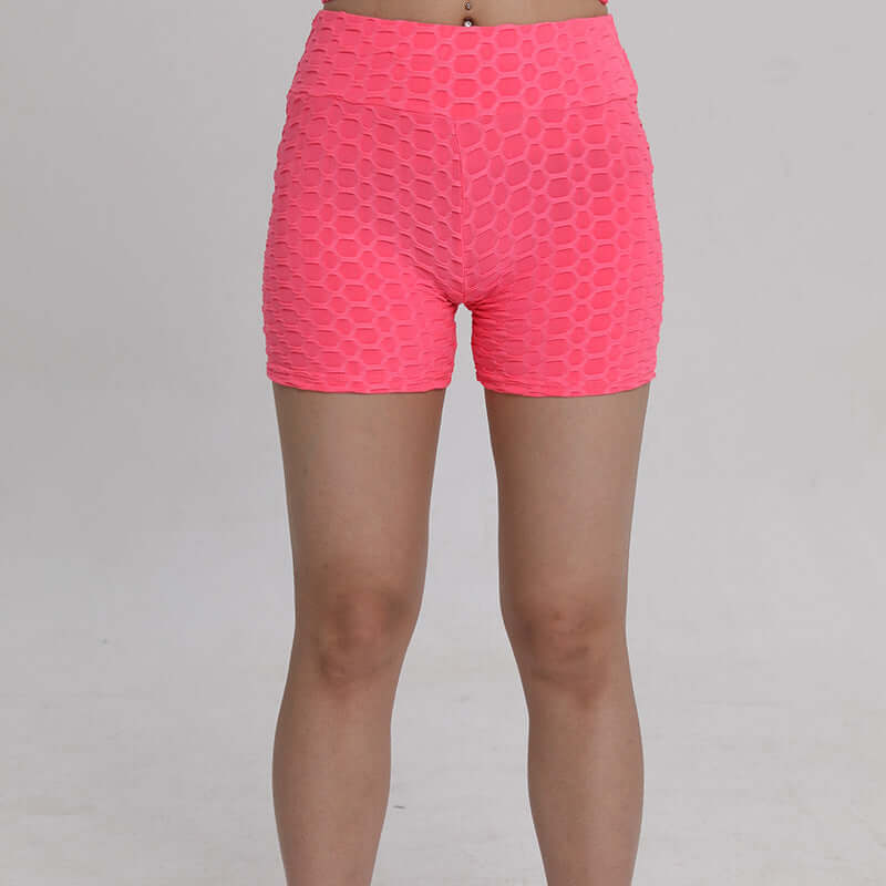 Pink high waist shorts with honeycomb texture, front view. Ideal for casual or workout wear.