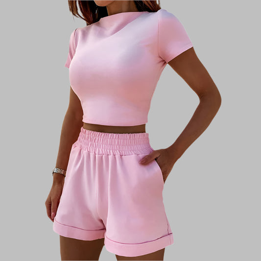 Women's pink casual sports suit with crop top and shorts, elastic waistband, perfect for comfortable and stylish summer wear.