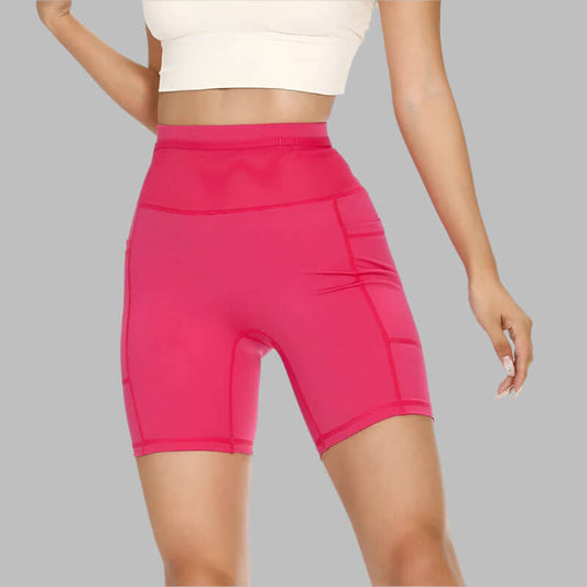 Women's pink compression shorts with high waist and snug fit for workout and sports activities.