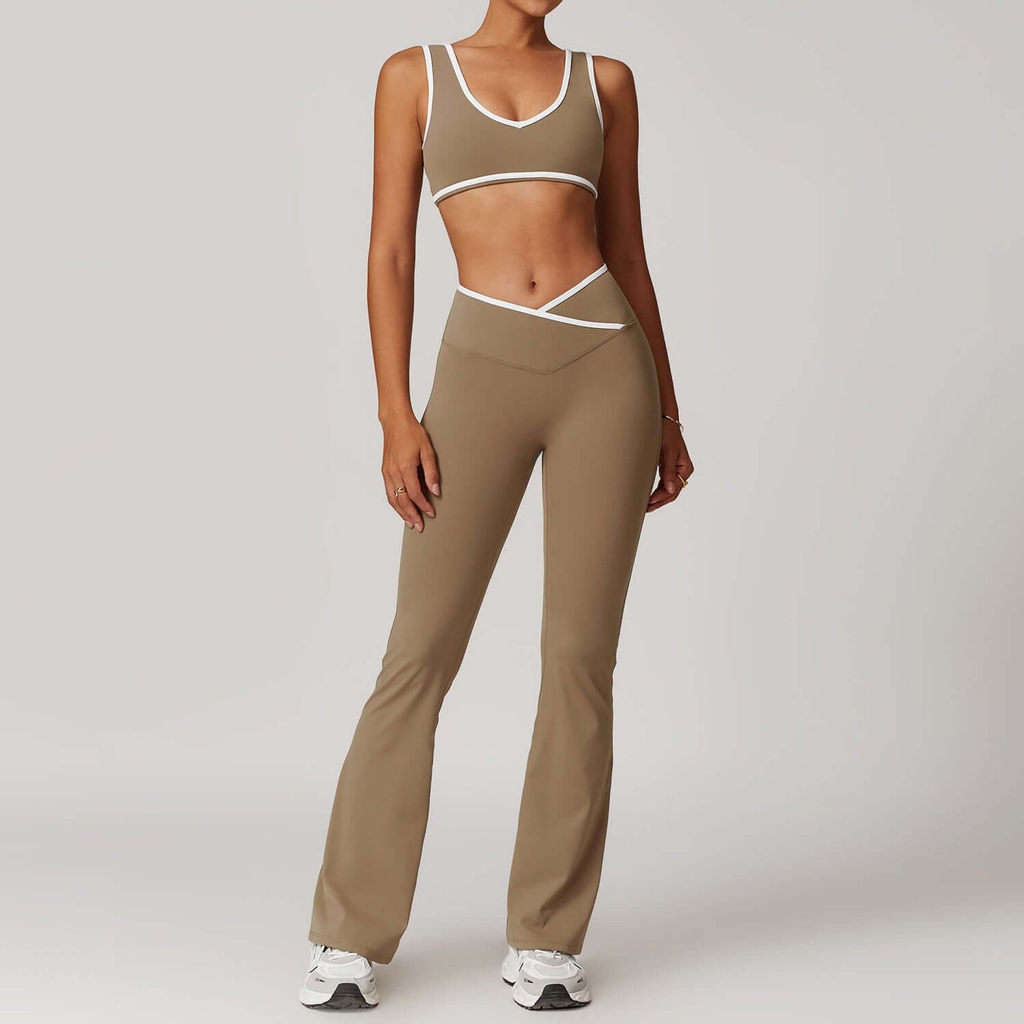 Woman wearing a 2-piece seamless yoga outfit in brown with white trim, highlighting stretchy, comfortable activewear perfect for gym or yoga.