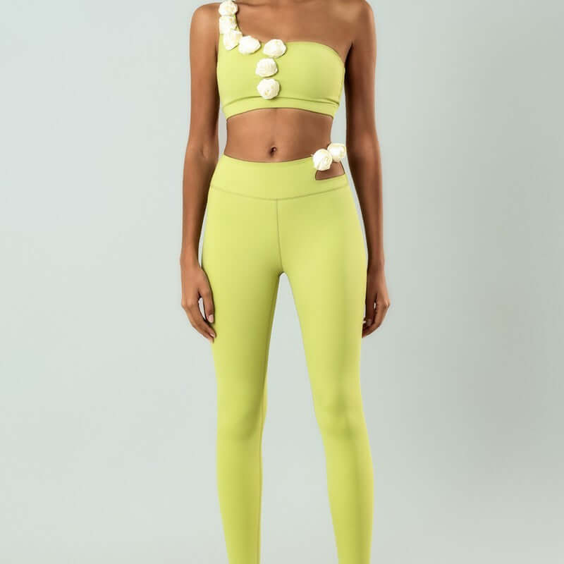 Stylish lime green high elastic set with floral embellishments, featuring one-shoulder top and high-waisted leggings.