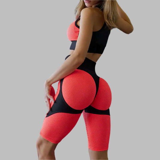 Women's workout fitness set with red textured leggings and sports bra, showcasing stylish gym wear. Ideal for active lifestyles.