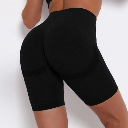 Close-up of black high-waisted compression shorts showcasing sleek design and contouring fit for athletic performance.