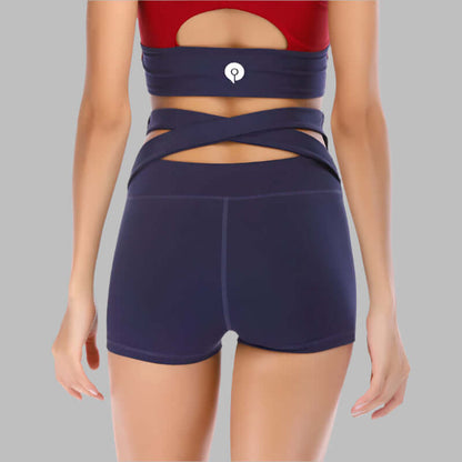 Woman modeling seamless yoga shorts with criss-cross waist design, perfect for activewear. Available in sizes S to XL.