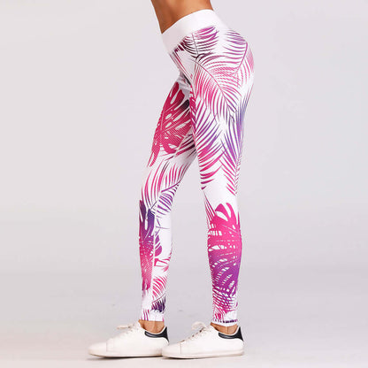 Woman wearing leggings with red and pink leaf print for yoga practice