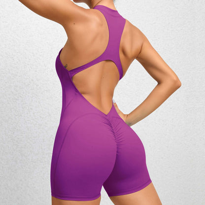 Woman wearing a purple zippered fitness romper made from organic cotton featuring a relaxed fit and breathable material.