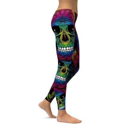 Woman wearing colorful rainbow skull leggings showcasing vibrant design.