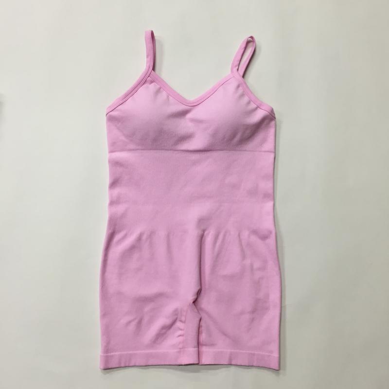 Pink seamless knit yoga jumpsuit made from organic cotton. Features a relaxed fit and breathable material.