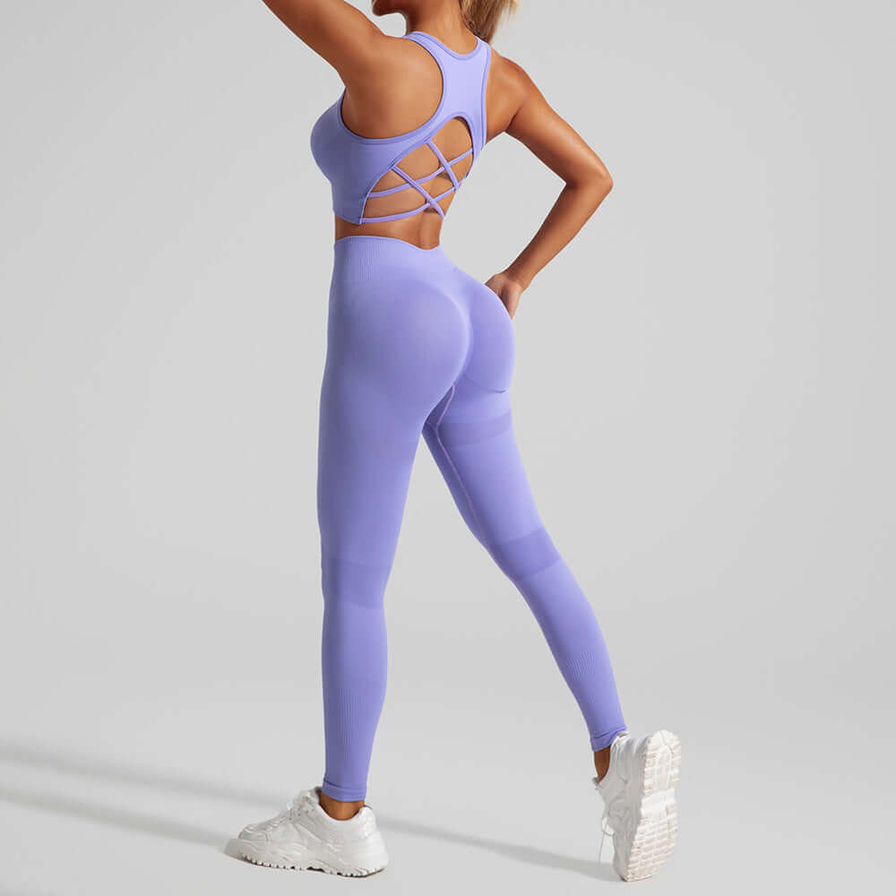 Woman wearing purple hip lifting sport leggings yoga suit, back view.