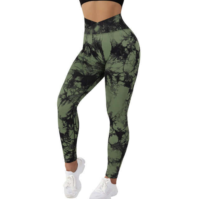 Green and black tie dye leggings with a high waistband, styled with white sneakers.