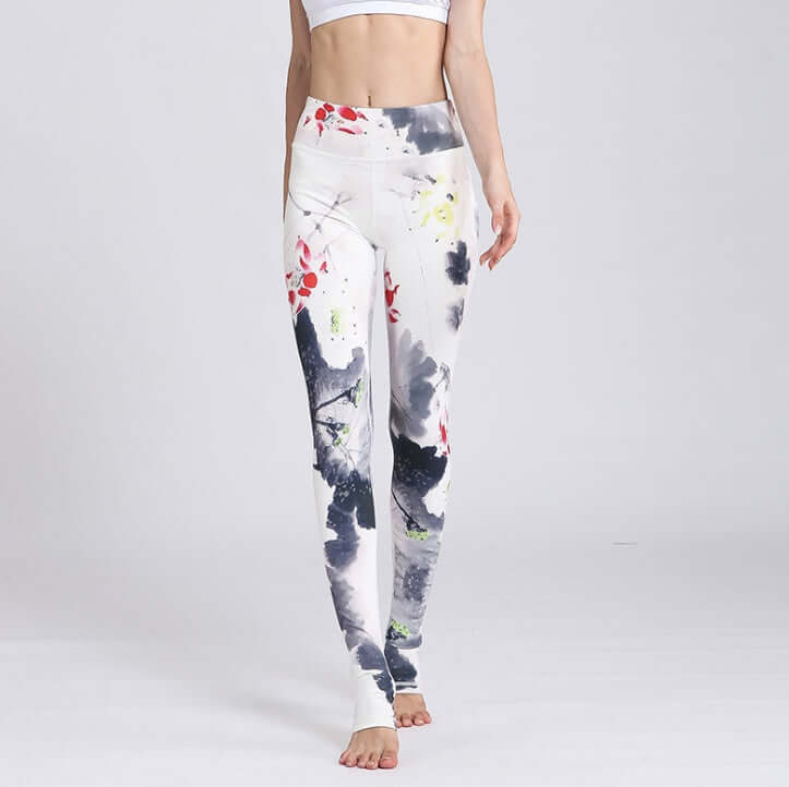 Woman wearing printed yoga pants with colorful abstract design, showcasing fitness fashion trends.