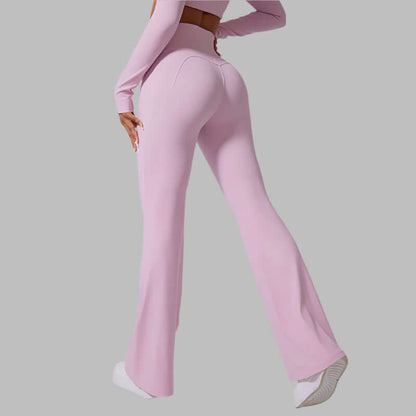 Back view of pink flared yoga pants with high waist, worn by a person showcasing the style and fit.