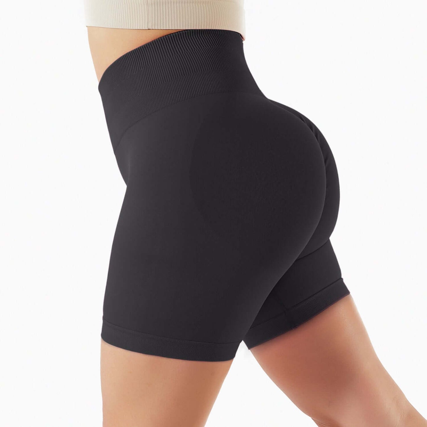 Woman wearing black seamless shorts with high waist, showcasing a comfortable fit and sleek design for athletic activities.