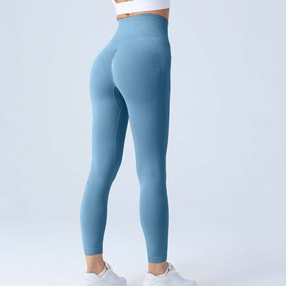 Woman wearing blue workout running leggings, showcasing high-waisted fit and flexibility. Available in sizes S, M, L for various weights.