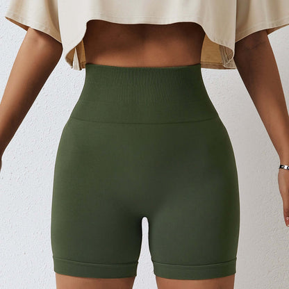 Woman wearing seamless high waist shorts in olive green, showcasing the high hips design for fitness or casual wear.