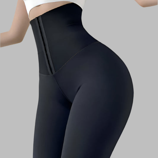 Woman wearing seamless compression leggings with high waist design in black, providing a sleek and supportive fit.