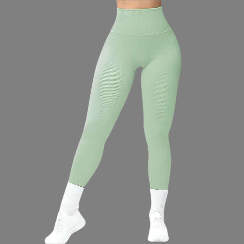 Model wearing green seamless fitness leggings, showcasing flexibility and comfort ideal for workouts. Available in sizes S to XL.