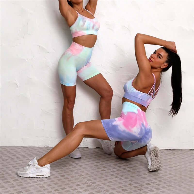 Women posing in colorful seamless sport sets, ideal for workouts, featuring vibrant tie-dye patterns and a comfortable fit.