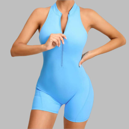 Blue zippered fitness romper made from organic cotton. Relaxed fit with breathable material for comfort during workouts.