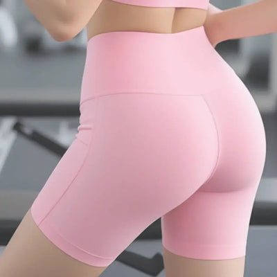 Pink booty-lifting sports shorts with high-waist fit, designed for comfort and support during workouts and activities.